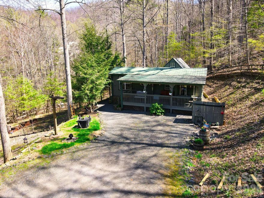 Now available—this is a once-in-a-lifetime opportunity to own a truly special mountain getaway nestled in the Blue Ridge at Dancing Leaf Lane. Featuring two unique tiny homes, this charming property is perfect for personal retreats, summer escapes, or even a short-term rental investment.

Escape to this peaceful setting and let your stress melt away. Ideal for weekend getaways or extended stays, the property offers a serene, park-like atmosphere with beautiful mountain views from the living areas and deck. In the winter, enjoy mountain views, while summer brings a lush, private canopy. You can even hear the soothing sound of a nearby rushing creek from the front yard (creek is nearby, not on property).

Both high-quality modular cabins—one log and one wood— offer everything you need and more. The main tiny home features a comfortable living and dining area, a well-equipped kitchen with propane range, a full bath, and a bedroom with two closets. Step outside to the covered front porch, complete with a large built-in picnic table—perfect for enjoying the cool mountain breeze.

The second tiny home provides additional space with a bunk area, loft, and half bath, making it ideal for guests or rental flexibility. Both cabins are equipped with Buckstoves with propane as well as window units for air conditioning.

Spend your evenings gathered around the firepit with friends and family, taking in the cool mountain air and starry skies. The property also features a gated entry, shared well, 200 AMP service, and a privately maintained road. Located just 0.6 miles from the fire department, this unrestricted property offers incredible versatility and potential.

Whether you're seeking a peaceful escape, a summer retreat, or an income-producing property, this one-of-a-kind mountain cabin experience delivers charm, comfort, and endless possibilities.