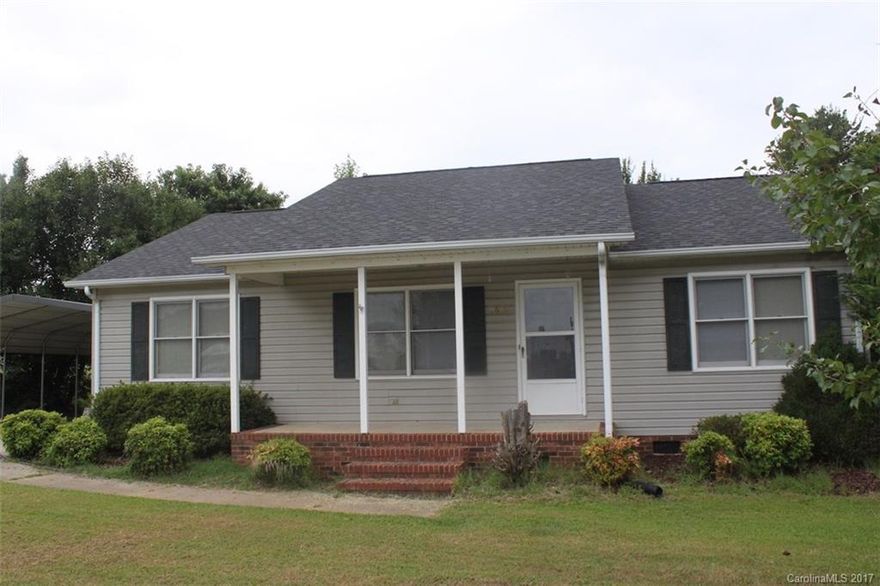 Spacious home with a great open layout.  Huge yard with a  great view.  Two-car carport, storage building and deck overlooking the backyard.  Rocking chair front porch.