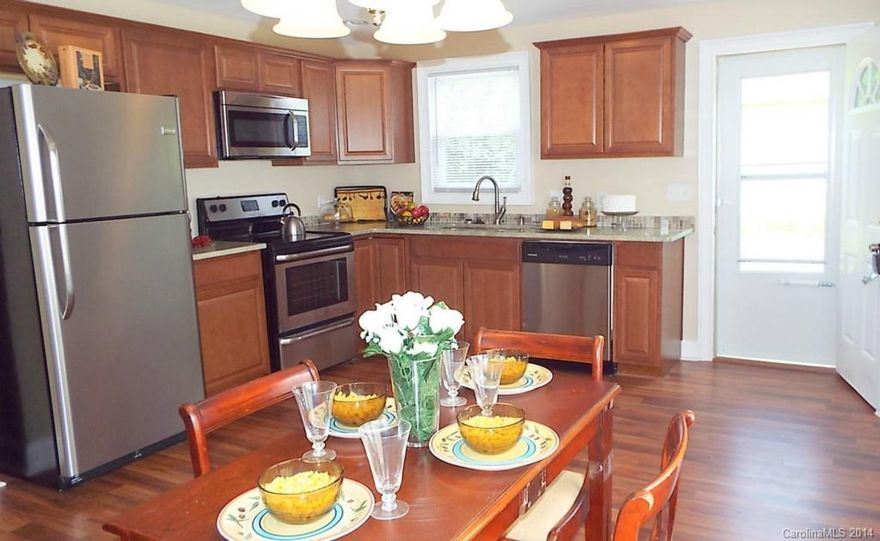 Beautifully remodeled 3 Bed, 2 Bath home with modern design.  Brand new Kitchen has cherry cabinets, brand new Stainless Steel appliances, granite countertops, and wood floor. Lots of parking with oversized two car garage and 6+ spaces in the driveway.  Wood floors in main living areas, and ceramic tile in baths. Big rocking chair front porch that wraps to side. Home is minutes from I-85, the new Bio Technology Research Campus, and shopping and medical centers.