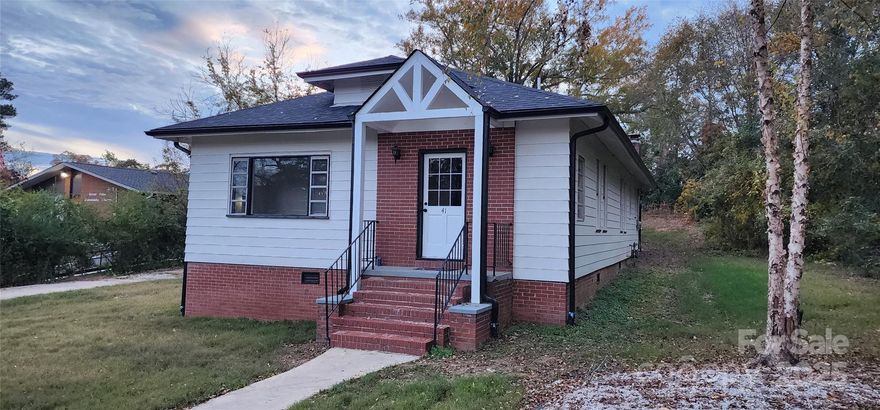 Don't miss a charming and completely remodeled home in the heart of Great Falls! Originally built in the 1930s, this single story home has a unique floor plan with two kitchens and two laundry hookups that would allow comfortable living as a 5BR/3BA or house hack and separate into two units to live as a duplex or multifamily (3BR/2BA and 2BR/1BA). Many original features remain to include hardwoods, windows, doors, kitchen sink and the fireplace mantle in the den is an original railroad tie from the old mill nearby. New roof, gutters, exterior paint, interior paint, refinished hardwood floors, refurbished original windows and doors, and updated baths/kitchens. Pull down attic with abundant storage. New front door November 2024 (white). Walkable to all of the Great Falls downtown amenities including the library, community center, Great Falls Elementary, grocery, and more.
