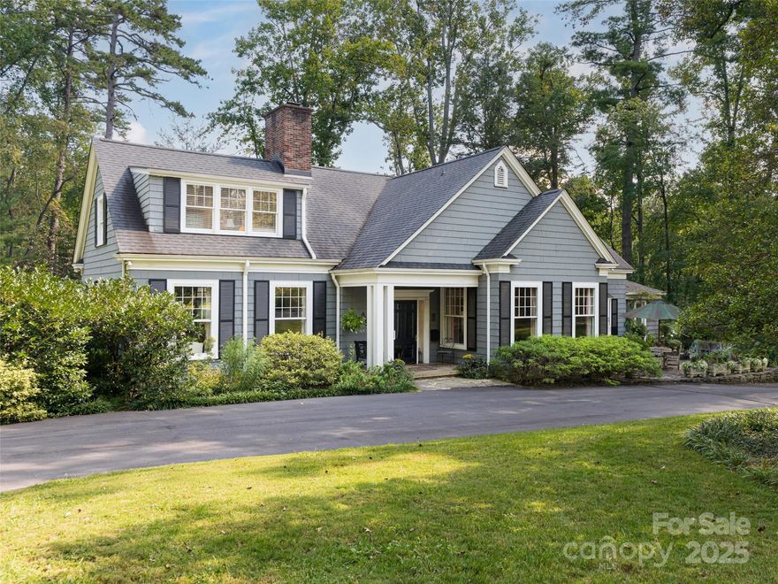 Sited on 2.65 private acres surrounded by a Smithsonian garden is this shingle style home, Boxwood Hill.
The patina of age hosts today's lifestyle with aplomb. Graciously large rooms with high ceilings and
light flooding in from three directions are ideal for entertaining or personal enjoyment. Located on one
of the Forest's most coveted streets, the home is across the park from Carolina Day School. Greenwood
Park, with its gentle stream and recreation areas is a popular spot for neighbors to gather. A short
distance away is the Blue Ridge Parkway and the Biltmore Forest Country Club ( membership required.)
Outdoor living is enhanced by surrounding terraces and gardens. The floor plan is flexible with a library
and a family room in addition to the formal rooms. The family room features a walk-in closet and a full
bath, providing the option for a primary bedroom on the main floor. Almost 1600 square feet of partially
finished and unfinished areas are located on the daylight basement level. One area was a former two car
garage and could easily be converted back to a garage without loss of finished square footage.  The primary features a sitting area and a spacious ensuite bath. There are three guest bedrooms with two baths.  If privacy, convenience and a lush garden lifestyle entrance you, this is your next home.