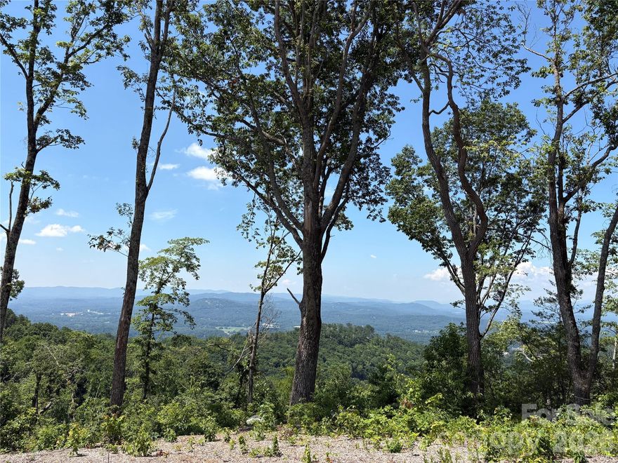 MOTIVATED SELLERS! Breathtaking views in almost every direction await the lucky buyer of this unique 3+ acre lot in the gated mountaintop community of Couch Mountain, an environmentally conscious neighborhood boasting a 138-acre nature preserve that includes hiking trails, apiary, and two flourishing community gardens with a greenhouse, all for use only by owners. Lot 50 is uniquely perched on a knoll above the road for maximum privacy, with the top of the lot having a gentle, cleared slope for an easier build. With construction on more than a quarter of the homesites already completed, you'll find plenty of inspiration for designing your own escape. Conveniently located between Asheville and Hendersonville, Couch Mountain consists of 81 large homesites on 395 acres of land. Use of renewable energy sources, green building techniques, smaller footprints, backyard gardens and native landscapes are encouraged. Come build your dream home on Couch Mountain! Lot is agent-owned.