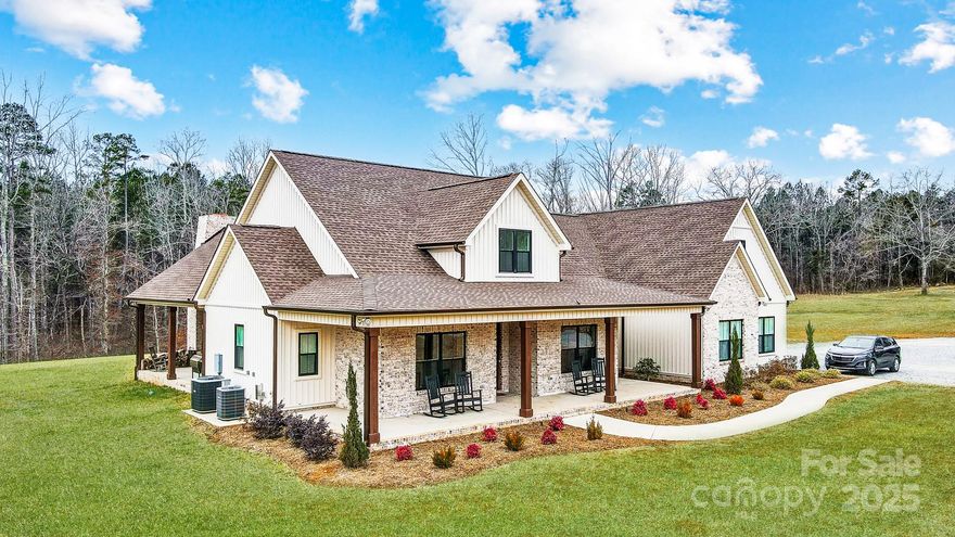 Secluded Retreat on 20.2 Acres tucked away between Lake Wylie & downtown Clover, this stunning custom home offers a perfect balance of privacy, modern comfort, & natural beauty. Elevated above a stocked pond with a covered dock, a perfect place to relax & unwind. Designed for everyday living & entertaining, the home features inviting outdoor spaces, including a welcoming front porch and an expansive rear covered patio with a wood-burning fireplace as the focal point for gatherings. Inside, the open floor plan is thoughtfully designed with a spacious kitchen island & walk-in pantry. The second floor includes a dedicated home theater for movie nights & family entertainment. The property itself is a rare find, offering a 3-stall pole building, a level cleared area ready for a barn, workshop, or riding arena, & a food plot near the creek. If you're looking for a private retreat with modern amenities and endless possibilities, this property is truly one of a kind! Award-winning schools!