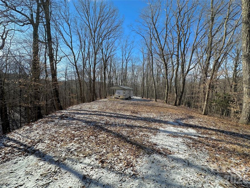 Majestic 8.74-acre property right outside of Banner Elk with multiple FLAT areas to build and infrastructure already in place! So many wonderful features about this property include great southern exposure, a shared well with an installed water line to a build site, a 2 bedroom septic system INSTALLED, underground power/fiber optic INSTALLED, and an RV pad with metal structure in place all at 4,000' elevation. Bold springs are on the property and one was used as a water source for many years. Wooded nature surrounds you with a seasonal view or the potential for a mountain ridge view with some tree clearing. The location could not be any better being less than 5 minutes to Banner Elk, with proximity to skiing, wineries, hiking, golf, tennis, equestrian facilities and more. Property could be subdivided and there are multiple building sites. A great estate tract or potential short-term rental compound. No deed restrictions but located in the Banner Elk ETJ for residential zoning.