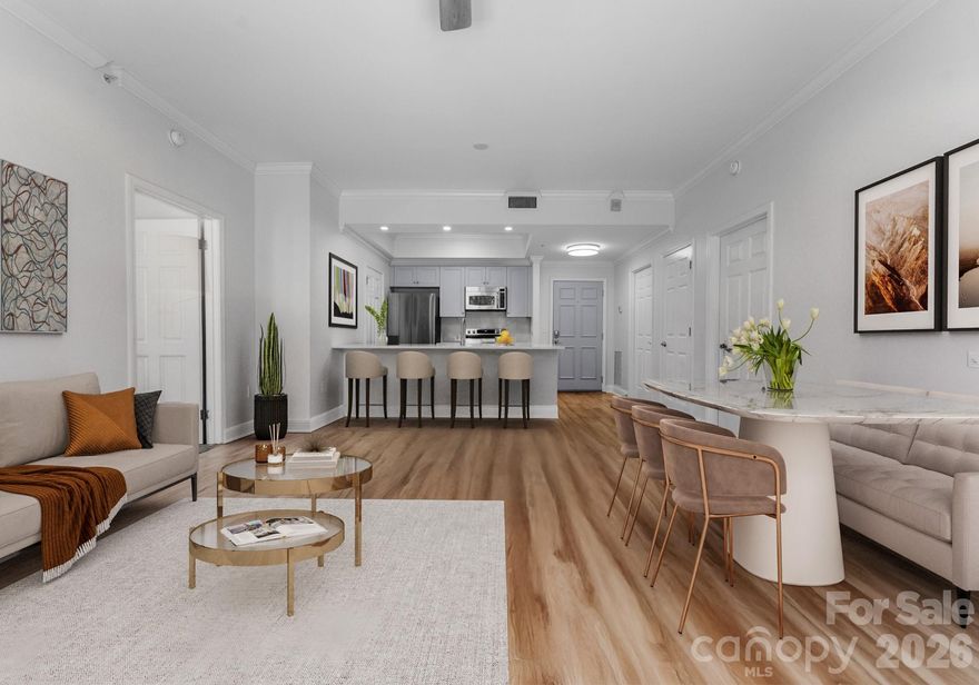 Downsizing? Right-sizing? 1st time homebuyer? Remote worker or work in Uptown? This 2 bed 2 bath modernized split layout home at sought after 5th and Poplar, is perfect whatever your lifestyle. Though compact in size feet, this home that features soft neutral toned LVP flooring & an open concept kitchen/ living /dining area is extremely functional and makes for easy living. 
The light filled airy space extends through sliding glass doors to the balcony that is perched above historic Settler's Park. The perfect spot to enjoy your morning coffee, check your emails, or unwind at days end!  The tasteful quartz countertop anchors a refreshed kitchen that features stainless steel appliances.  The primary bedroom's casement windows bring nature indoors making the room serene & cozy. The second en-suite bedroom makes a perfect home office/tv room or dedicated bedroom with walk-in closet.  Both bathrooms have new quartz countertops & toilets. 

New Samsung & LG appliances, quartz sink, ceiling fans & lighting. Walk in pantry/laundry with new stackable LG washer/dryer. Secure deeded parking. Meticulous homeowners replaced water tank & HVAC condenser 2023, window hardware, sliding door rollers & hardware. 

Located in the Fourth Ward, 5th & Pop is just blocks from all the sports stadiums & arenas, dining, museums, theatre, the light rail and situated between parks.

Building updates: New roof 2023, hall carpet & paint 2022. No planned assessments. 

LIVE THE TURN KEY RESORT LIFESTYLE AT 5TH & POPLAR: FULL TIME ON SITE CONCIERGE & AWARD WINNING ON SITE HOA management., pool w outdoor kitchen, professionally landscaped gated courtyard w putting green, fountain, dog park, state-of-art fitness center, cozy library w gas fireplace, fireside terrace w TV & grills, media room, cyber & coffee cafes&  resident car wash. 2 full time supers & maintenance staff, HARRIS TEETER, NAIL SALON & DRY CLEANERS in the building. Digital bulletin board.  On and off site activities including Book Club, Coffee & Conversation, Happy Hours, Bingo & More!