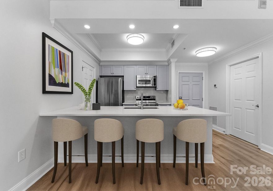 Just in time for Spring & Summer!  Spend days by the pool sunbathing, swimming, grilling and hitting a few balls on the putting green!  If you are traveling this summer, the ease of living in this 2 bed 2 bath modernized split layout home at sought after 5th and Poplar, is perfect! Lock and go! The concierge will hold your packages and mail till you return! This beautifully updated open concept home features new quartz kitchen countertops and back splash, soft neutral toned LVP flooring, new stainless steel appliances, lighting and ceiling fans.
The light filled airy space extends through sliding glass doors to the balcony that is perched above historic Settler's Park. The perfect spot to enjoy your morning coffee, check your emails, or unwind at days end! The primary bedroom's casement windows bring nature indoors making the room serene & cozy. The second en-suite bedroom makes a perfect home office/tv room or dedicated bedroom with walk-in closet.  Both bathrooms have new quartz countertops & toilets. 

New Samsung appliances, quartz sink, ceiling fans & lighting. Walk in pantry/laundry with new stackable LG washer/dryer. Secure deeded parking. Meticulous homeowners replaced water tank & HVAC condenser 2023, window hardware, sliding door rollers & hardware. 

Located in the Fourth Ward, 5th & Pop is just blocks from all the sports stadiums & arenas, dining, museums, theatre, the light rail and situated between parks. Be privy to Friends of Fourth Ward events especially the highly anticipated Secret Garden & Home Holiday Tours!

Building updates: New roof 2023, hall carpet & paint 2022. No planned assessments. 

LIVE THE TURN KEY RESORT LIFESTYLE AT 5TH & POPLAR: FULL TIME ON SITE CONCIERGE & AWARD WINNING ON SITE HOA management., pool w outdoor kitchen, professionally landscaped gated courtyard w putting green, fountain, dog park, state-of-art fitness center, cozy library w gas fireplace, fireside terrace w TV & grills, media room, cyber & coffee cafes&  resident car wash. 2 full time supers & maintenance staff, HARRIS TEETER, NAIL SALON & DRY CLEANERS in the building. Digital bulletin board.  On and off site activities including Book Club, Coffee & Conversation, Happy Hours, Bingo & More!