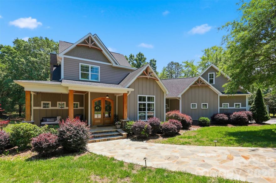 This 2017 custom built Craftsman style beauty sits on a private 1.06 acre lot in beautiful Fort Mill, South Carolina! As you approach the home, notice the large circular driveway, how the home is perfectly situated on the large acre lot, the cozy stone front porch with swing, the tall double doors leading inside. While inside, you may just want to move in right away - I certainly did! Be welcomed by the circular staircase, the lovely dining room, private office with barn door, this private living area - with fireplace, mantle, built-in's, an "almost" full wall of windows - adjoins "that" kitchen - yes, "that" kitchen that almost everyone dreams of - offering large island, amazing counter space, cabinetry space, expansive countertops, gas cooktop with hooded vent, pot filler and tile backsplash. Let's not forget the spacious pantry, eating area and all those finishes! Just beyond the transition hall, lies the primary ensuite. Primary boasts trey ceiling and amazing trim and adjoins that primary bath retreat.......(more coming soon)......