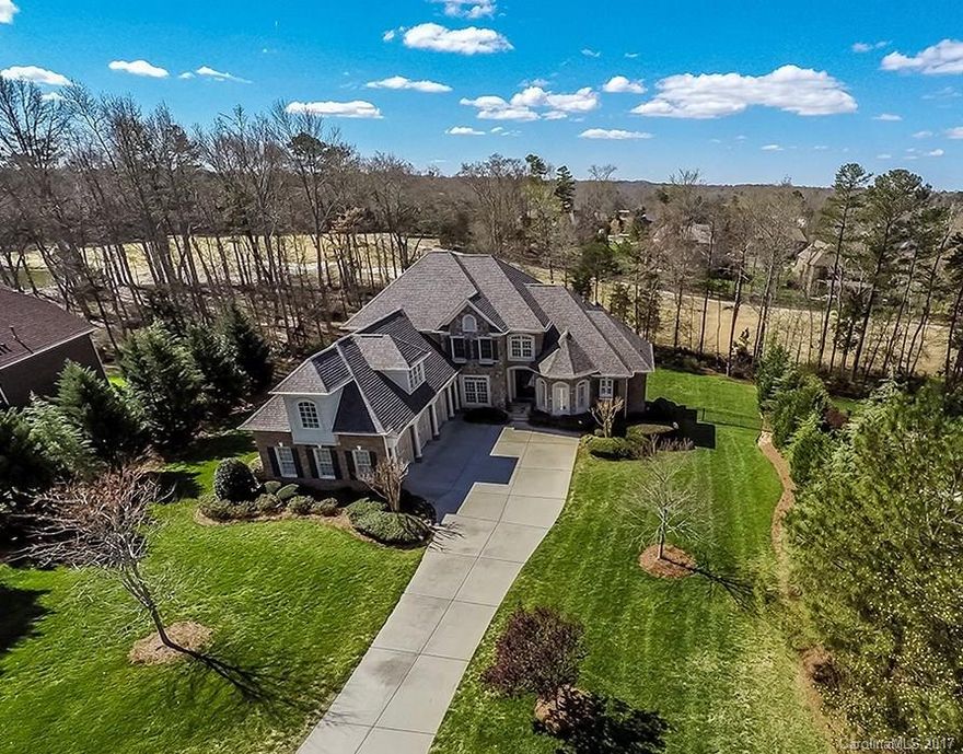 Stunning & Spacious Brick/Stone/Stucco Estate with exceptional Golf Course views & amazing Entertain Spaces inside & out. On cul-de-sac street. Soaring 20' Living Room w/vaulted ceilng & abund. light from window wall. Huge Chef's Kitchen & B'fast w/adjoin Vaulted Hearthroom. Master Suite & Guest Suite on Main. Huge Lowr Lvl Entertain/Living/Kitchen PLUS 1,100+ Unfin sf. Builtins galore, Surr. Sound. Great Outdr Areas, FP & Fenced Yd. Close to Ballantyne & Blakeney shops/restaurnts. Low SC Taxes.