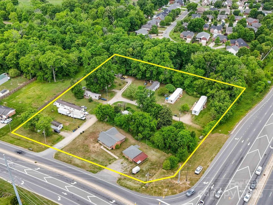 With all the excitement surrounding Weddington Road  and George Liles Parkway this is  a Great Corner Parcel in this rapidly developing area. You can't find acrage like this in a location like this!!  Located at the signalized intersection of George Liles Parkway and Weddington Road, directly across the street from the Publix shopping center. Currently Zoned MX-NC (mixed use - neighborhood center) with potential to be rezoned commercial. There are 8 rented mobile home lots ($400/month each) and 1 rented single family home ($1800/month) currently on this property.
