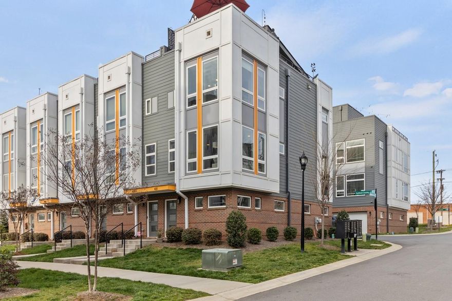 Beautiful contemporary townhome in desirable South End! Great location with community picturesque skyline views! Walking distance to light rail, restaurants, shops, breweries as well as minutes away from Uptown Charlotte. This sought after end unit has a bump out in the living room & primary bedroom which provides additional square footage and tons of windows for natural light. Stainless steel appliances, tiled backsplash, open shelving, quartz countertops, roll out pantry drawers, and open floor plan. Tandem 2 car garage offers plenty of space for 2 vehicles and additional workout/ storage space. Many upgrades throughout this unit including frameless shower doors in the primary bath, custom window blinds, epoxy garage floors, custom closets in both bedrooms & more. Relax & unwind on either the covered balcony on the main level or watch the sunset on the beautiful rooftop terrace! You don't want to miss this one!