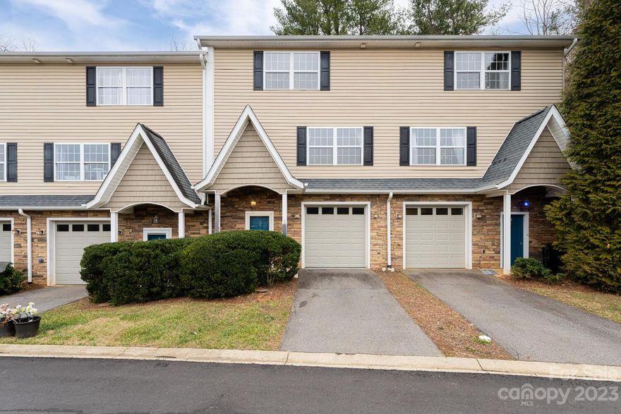 Discover the Woodfin/NAVL lifestyle of ease & convenience, paired w/ sophisticated living, across 3-levels. Main floor welcomes you w/ a generously sized eat-in kitchen seamlessly connected to the spacious living area, complemented by a half bath, laundry, & backyard access including a private deck. Kitchen boasts SS appliances & expansive cabinetry for abundant storage & counterspace perfect for entertaining. Ascending to the upper level, the primary bedroom awaits, complete w/ ensuite full bath & walk-in closet along w/ 2-additional bedrooms & a well-appointed full bath. Lower-level unveils a versatile bonus space, ideal for an office or workout area, accompanied by a full bath & a convenient 1-car garage. Situated minutes from UNCA, Silverline Park-Woodfin, downtown AVL w/ shopping, restaurants, breweries galore while offering easy access to I26 & other amenities-this townhome is a perfect blend of ease & accessibility.