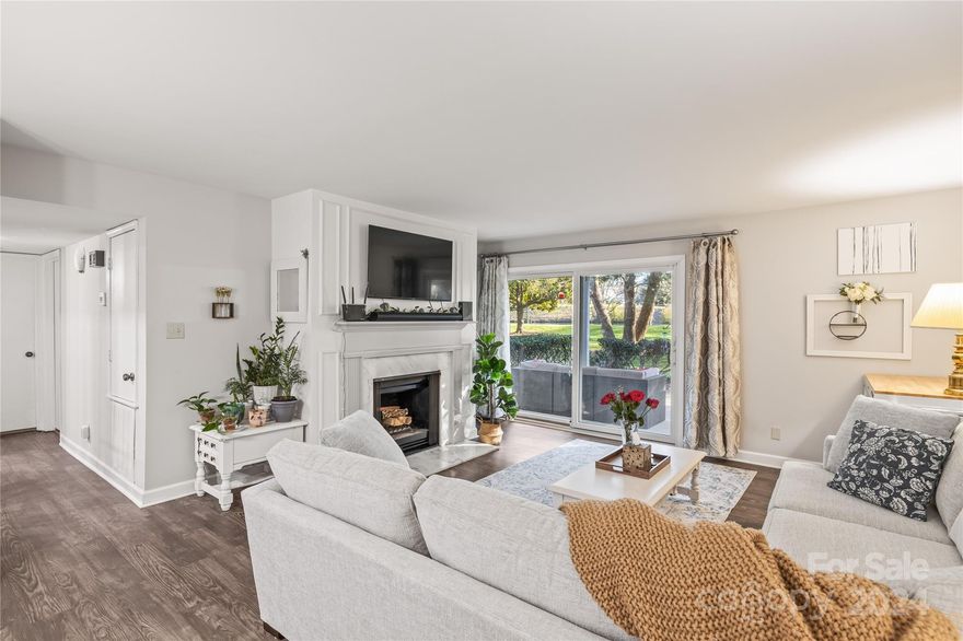 This beautifully updated 2 bed / 2 full bath condo is a rare find in Quail Hollow! The ground level entry makes access easy plus (thanks to being an end unit) offers a private and covered back patio overlooking a gorgeous and peaceful pond. Boasting nearly 1200sqft of interior open living space, the natural flow combines original architecture with modern function. Embrace luxurious touches including a custom-built walk-in primary closet, fully renovated primary bathroom, new paint and updated accents throughout, luxury vinyl plank flooring, and subway tile kitchen backsplash. Gather by the (fully functional and frequently used) wood-burning fireplace with a stunning carrera-style stone surround. Experience elegance in every detail at a price hard to find in this part of town! As if that's not enough, amenities include a clubhouse, pool, tennis courts, and walking trails. There's also two parking spots included - one covered with a storage closet and one assigned in the parking lot.