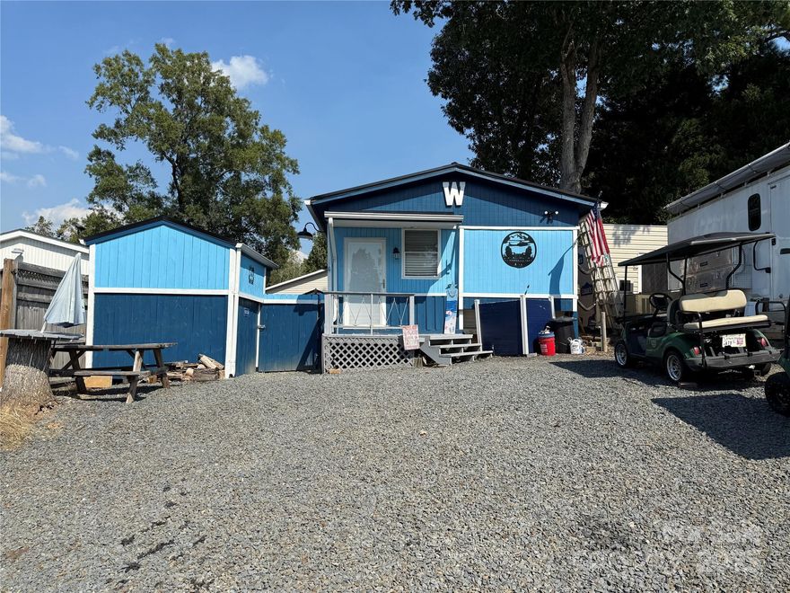 Welcome to this unique unit here in the park. This a 2 bedroom, 2 1/2 baths unit with a fabulous outdoor kitchen setup and a second sleeping/bathroom space. Included in the outdoor kitchen -  Blackstone Gas Griddle, Blackstone Prep Area, covered with elec and fan. Move over to the covered bar side and you have 4 stools, a beverage refrigerator, Microwave, Ninja Foodie Grill, Panini Maker, Oster French Door Oven. Power and a TV are already there. There is a covered swing, fenced yard for the pets and a pet washing station. Inside is a great living room freshly painted with new flooring. Most furnishing to remain. U shaped couch makes a comfortable queen bed. The kitchen has an ice maker, great counter space and brand new flooring. Metal roof is 1 year old. Propane Hot Water on Demand 2 years old. 2 Window units for AC and a wall mounted propane heater for your heat source. Access door just added to the side of unit for the convenience of letting the dogs out into the fenced area. Full bath with walk in shower. Storage or Sleeping loft above main bath room. Double size bed and 1/2 bath on the camper side. Out back is double bunks, a full bath and enough room to add a washer and dryer if desired. Portable A/C and fan.
Come and see if this is your "Happy Place" here in the Park. No title to camper, Bill of Sale will be provided. 
There are 2 Yamaha 2011 golf carts available for Alum wheels $4k, black wheels $3k. 
All buyers must be with a realtor to gain access to the community.