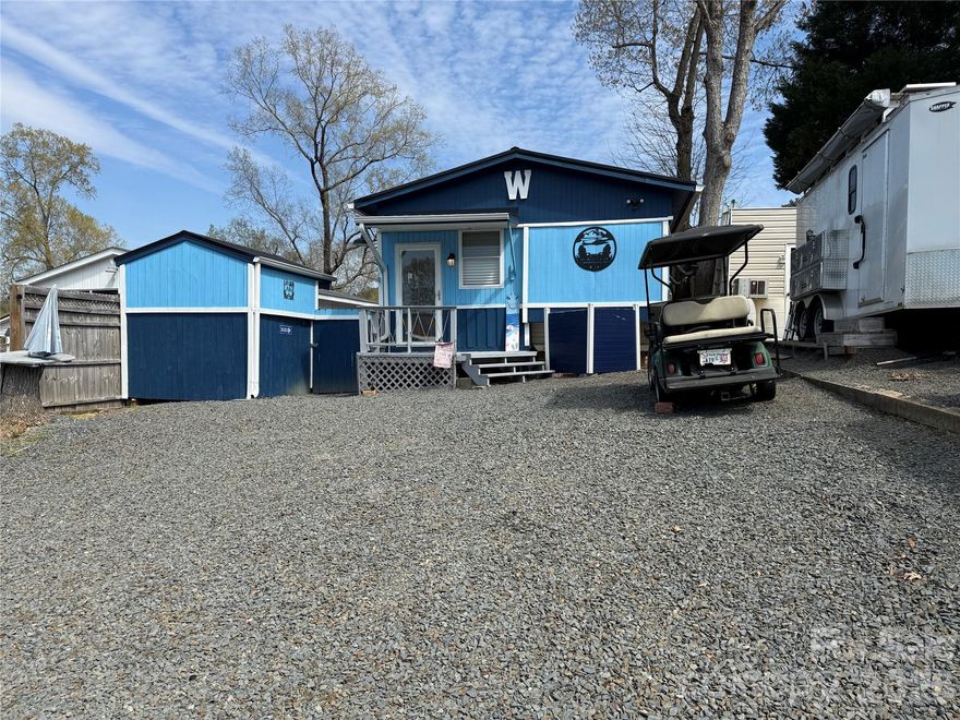 Welcome to this unique unit here in the park. This a 2 bedroom, 2 1/2 baths unit with a fabulous outdoor kitchen setup and a second sleeping/bathroom space. Included in the outdoor kitchen -  Blackstone Gas Griddle, Blackstone Prep Area, covered with elec and fan. Move over to the covered bar side and you have 4 stools, a beverage refrigerator, Microwave, Ninja Foodie Grill, Panini Maker, Oster French Door Oven. Power and a TV are already there. There is a covered swing, fenced yard for the pets and a pet washing station. Inside is a great living room freshly painted with new flooring. Most furnishing to remain. U shaped couch makes a comfortable queen bed. The kitchen has an ice maker, great counter space and brand new flooring. Metal roof is 1 year old. Propane Hot Water on Demand 2 years old. 2 Window units for AC and a wall mounted propane heater for your heat source. Access door just added to the side of unit for the convenience of letting the dogs out into the fenced area. Full bath with walk in shower. Storage or Sleeping loft above main bath room. Double size bed and 1/2 bath on the camper side. Out back is double bunks, a full bath and enough room to add a washer and dryer if desired. Portable A/C and fan.
Come and see if this is your "Happy Place" here in the Park. No title to camper, Bill of Sale will be provided. 
There are 2 Yamaha 2011 golf carts available for Alum wheels $4k, black wheels $3k. 
All buyers must be with a realtor to gain access to the community.