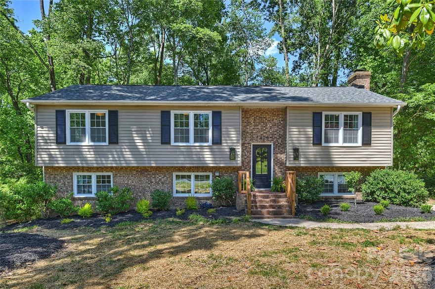 Completely remodeled and ready to impress, this stunning home offers 4 bedrooms, 3 full baths, and a seamless blend of style and functionality. From the moment you step inside, you’ll be captivated by the open floorplan, designed to make both daily living and entertaining a breeze. The heart of the home is the chef’s kitchen, boasting a spacious island, sleek quartz countertops, brand-new stainless steel appliances, and a dining space with built-ins that provide ample storage. The main level features three beautifully appointed bedrooms and two full baths, each showcasing chic, on-trend vanities that add a touch of modern elegance. Upstairs, one of the bedrooms includes an ensuite bath—perfect for guests or a second primary. Downstairs, the second living area exudes charm with its moody palette and cozy fireplace, the perfect spot to relax and unwind. The expansive primary suite is a true sanctuary, complete with a large walk-in closet, a stunning ensuite bath featuring a fluted dual-sink vanity, a glass walk-in shower, and an adjacent flex space ideal for a home office or gym. Step out onto the serene deck overlooking a peaceful, wooded backyard that feels like your own mountain escape. Whether you’re sipping your morning coffee or unwinding in the evening, this outdoor space is pure tranquility. Nestled in the established Heritage Woods neighborhood, this home is centrally located between Matthews and Cotswold and just minutes from Uptown Charlotte. Plus, it’s in the coveted Private School Corridor, close to some of the city’s top-rated schools. With fully updated finishes, thoughtful design, and an unbeatable location, this home offers incredible value for modern living in Charlotte. Don’t miss your chance to make it yours!
