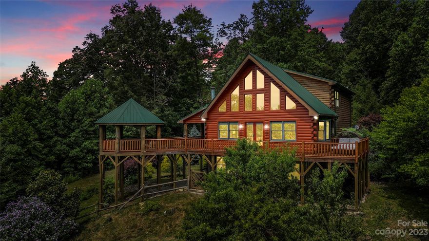 Immerse yourself in the beauty of this luxurious log cabin, where new hardwood maple floors set the stage for two peeled pine columns that reach up to meet the tongue and groove cathedral ceiling. As temperatures drop in the mountains, you'll be choosing between warming your bones by either of the two fireplaces in the home, one in the primary bedroom and one in the living room. 

Indulge in ultimate relaxation as you soak in the gazebo-covered hot tub, surrounded by the  transformation of autumn leaves. 

Nestled within the esteemed 3,000 Acre Gateway Mountain community, this haven grants you access to a picturesque waterfall and the serene private Lake George. Hiking, swimming, as well as catch and release fishing are readily accesible with this slice of paradise. 

35 Minutes to Asheville, 15 to Black Mountain. STR's are permitted.