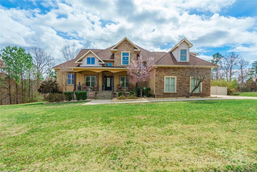 Exceptionally stunning home with convenient access to Lake Wylie, located in the Clover School District with 4 bedrooms! This beautiful home sits on a one-acre wooded lot in a lakeside neighborhood with no HOA fees. The oversized rocking chair front porch leads to a space with hardwood floors, a stone fireplace, 18’ ceilings, and built-ins. Sliding doors open to a veranda spanning the great room, breakfast nook, and primary bedroom. The gourmet kitchen features granite countertops, soft-close cabinets, induction cooktop, and under-cabinet lighting. Upstairs, enjoy two generous bedrooms and a bonus room/bedroom with a walk-in closet, private bath, and built-in bar with a mini fridge, sink, cabinets, and granite countertops. Outdoors, relax in the custom-built 15,000-gallon shotcrete saltwater pool with a sundeck, plus a two-tiered screened deck with a ceiling-mounted screen. This immaculate home has it all! See the attached write-up for full details!