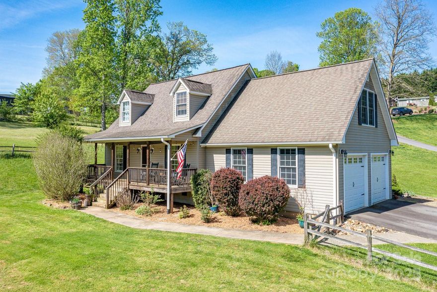 Welcome to 122 Ramsey Road! This meticulously maintained mountain home offers the perfect blend of country charm and modern convenience, all within a short 20-minute drive to downtown Asheville. The residence features a welcoming rocking chair front porch and a spacious, level front yard. Inside, the main-level primary suite provides an elegant retreat, complete with double sinks, a large soaking tub, and a walk-in closet. The kitchen is well-appointed with a central island and a cozy breakfast nook, ideal for casual dining. Upstairs, you'll find two additional bedrooms, offering plenty of space for family or guests. The expansive bonus family room provides additional room for relaxation or entertainment. For added convenience, the home includes an oversized two-car garage, perfect for your car enthusiast, extra storage, or shop space. This exceptional property is a rare find—don’t let the opportunity pass you by.