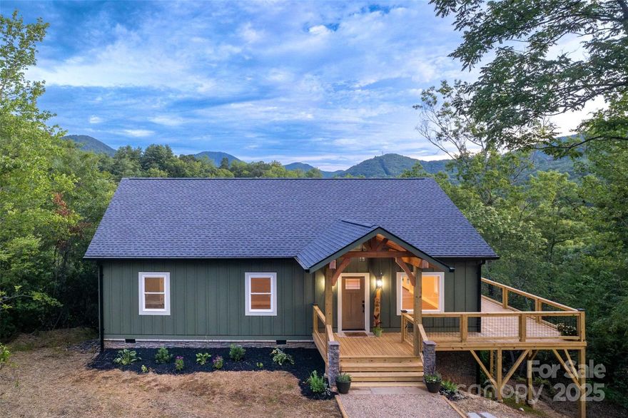 Brand-new, luxurious 3br/2ba in Cole Mountain Estates, Sylva, NC. Offering a treetop feel with mountain views from the deck and living areas, this home features high end finishes like custom granite countertops, a black walnut topped island, luxury cabinetry, a KitchenAid downdraft range, 9' ceilings, hybrid resilient flooring, and an open concept layout. Primary suite includes dual closets and a large picture window. Primary bath boasts a 6 foot double vanity and custom tile shower with river rock and frameless glass surround (coming soon). Quality build with Zip System sheathing, LP SmartSiding, Pella windows, enhanced roof protection and soft close cabinets/drawers throughout. Large unfinished crawl space serves as storage or potential expansion. Neighborhood offers a superb mountain lifestyle with higher end sensibilities. Located 8 mins from Dillsboro and within the Fairview Elementary district; this home is ideal for a full-time residence, vacation home, or investment property.