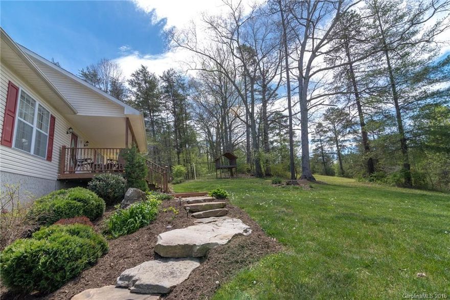 Peaceful country setting with rolling pasture and long range mountain views AND only 15 minutes to downtown Asheville. Private and surrounded by beautiful landscaping. Outdoor space with covered rocking chair front porch and open back decks. Upper level has master bedroom & bath, 2BR and full bath, kitchen, dining area, living room. Lower level daylight basement has 9 ft ceilings, den with fireplace, bonus room, full bath, 2 car garage, laundry room and walkout patio.