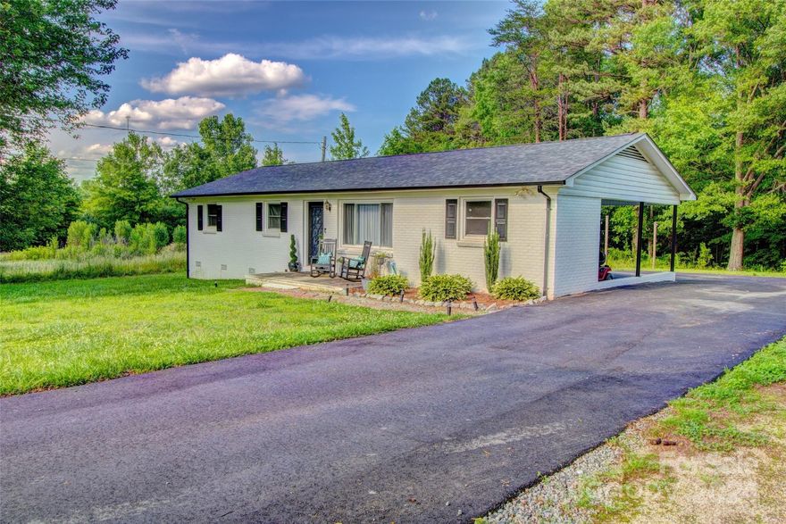 Nestled in a peaceful cul-de-sac, this charming, recently updated home is conveniently located near downtown Lincolnton, with easy access to Hwy 150 and 321. Situated just 20 minutes from Gastonia and 35 minutes from the Charlotte airport, this property features an inviting open-concept dining, kitchen, and family room area, three bedrooms, and a spacious bathroom. The kitchen is a highlight, boasting a big island with bar seating and a wood top, a dining area, a glass door that leads to the rear deck, and stainless steel appliances, including a microwave, range, dishwasher, and refrigerator. Updates, such as a new roof and HVAC system (manufactured in 2019), as well as new flooring, kitchen, bath, and more, were completed in 2020. In addition, the property includes a nice outbuilding, a welcoming rear deck, an asphalt driveway, and a convenient carport, including a storage closet with a laundry area. The home is move-in ready!