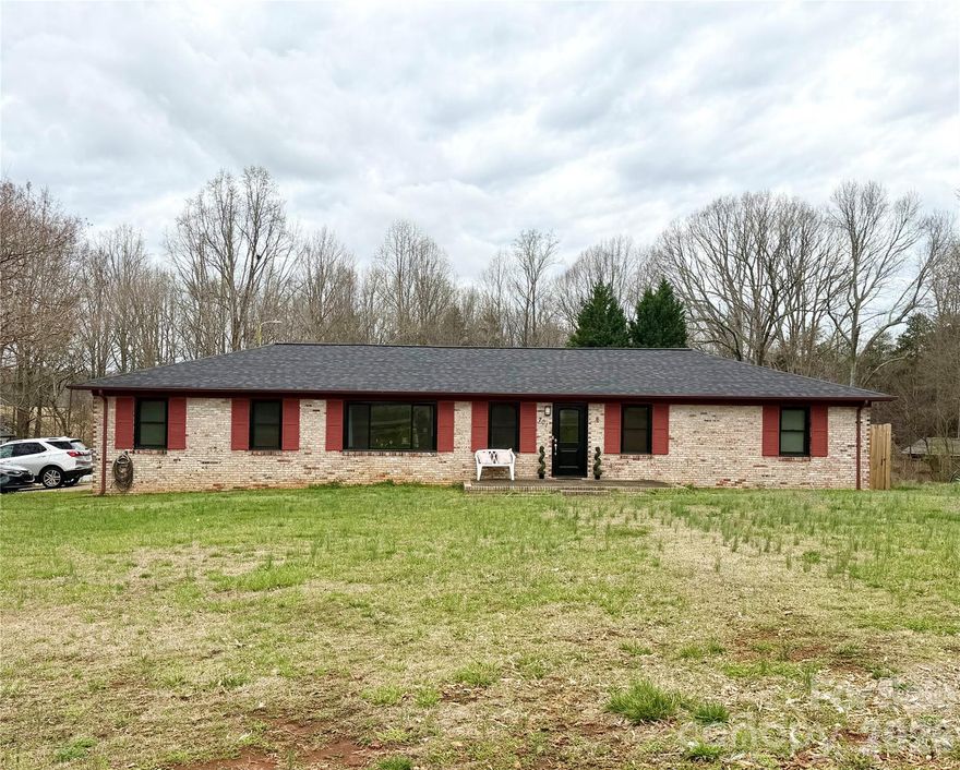 Move-in ready and beautifully updated! Welcome to this well-maintained 3-bedroom, 2 full bath home located at 170 Cherry Lane in Shelby, NC. Built in 1972, this home offers an inviting open floor plan that provides comfortable living and easy flow between the main living areas. The updated kitchen features granite countertops, custom cabinetry, and stainless steel appliances, creating a stylish and functional space for cooking and entertaining. Both bathrooms have been updated, offering modern finishes and convenience. Situated on approximately 0.46 acres, the property includes a fenced backyard ideal for pets, a large back porch perfect for outdoor gatherings, and an outbuilding for additional storage or workshop space. The corner lot provides added space and curb appeal in a well-established neighborhood. Conveniently located in the Springmore/Crest school district with close proximity to Highway 74, shopping, dining, and everyday amenities, this home offers both comfort and accessibility.