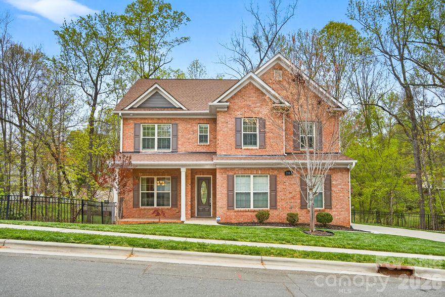 Quietly positioned at the end of a cul-de-sac in south Charlotte, this all-brick home offers a rare combination of privacy, quality construction, and thoughtful design. The floorplan feels spacious and well-composed throughout — the kind of layout that accommodates real life without sacrificing style. Mature trees, a wooded backdrop, and no immediate neighboring homes create a naturally secluded setting, while the location keeps everyday convenience well within reach.

Inside, tall ceilings and oversized interior doors lend the main level a refined, airy character. Finishes and upgrades throughout are polished and intentional, giving the home a distinctly elevated feel.

The kitchen is a true centerpiece — anchored by a large island and breakfast bar, with generous counter space, a sunny eat-in area, and a walk-in pantry that keeps things beautifully organized. A butler's pantry adds additional prep and storage space, making entertaining feel seamless. The kitchen opens directly into the living room, where a gas fireplace adds warmth and ambiance — an ideal layout for gathering, hosting, and everyday connection. A separate formal dining room sits just off the kitchen, ready for the occasions that call for a proper table setting.

 The sunroom extends the living space beautifully, offering a bright, comfortable room that works year-round — morning coffee, a reading nook, or a relaxed space to enjoy views of the wooded backyard. Outside, the fenced yard and brick paver patio provide a private, tree-lined setting ideal for outdoor dining, entertaining, or simply unwinding.

The large main level suite is a genuine standout — spacious, private, and appointed with a full bath and walk-in shower. Whether for guests, extended family, or multigenerational living, it functions as a true retreat rather than an afterthought.

Upstairs, the primary suite delivers an elevated sense of comfort, with a tray ceiling, soaking tub, separate shower, and generous vanity space — a well-designed escape at the end of the day. Additional bedrooms are well-proportioned and thoughtfully sized, with one oversized room offering real flexibility as a media room, home gym, playroom, or whatever the next chapter calls for. An upper-level laundry room adds the kind of everyday practicality that's easy to appreciate.

The outdoor living space is a true extension of the home and every bit as considered as the interior. A custom brick paver and stamped concrete patio wraps the back of the house with a finished, intentional feel, anchored by a curved natural stone seating wall that's as functional as it is beautiful. Mature trees surround the property on all sides, creating a canopy of privacy that feels truly tucked away. Whether you're entertaining under the trees, enjoying a quiet evening by a firepit, or simply taking in the view — this backyard delivers that rare, secluded feel that's hard to find this close to the city.


A side-entry garage and quiet cul-de-sac positioning add to the home's refined curb appeal, while the all-brick exterior ensures lasting quality and low maintenance.

Set in one of southeast Charlotte's most established and convenient corridors, the home is minutes from The Arboretum at Providence Road and Highway 51, with a strong mix of everyday shopping, dining, and services. Downtown Matthews is just down the road, offering a charming small-town feel, local restaurants, and the region's largest producer-only farmers market. SouthPark — Charlotte's premier destination for luxury retail and fine dining — is an easy drive, and major corridors provide straightforward access to Uptown and the broader metro. This home provides the best of both worlds: a private, serene setting with every convenience, restaurant, and entertainment option right at your doorstep.