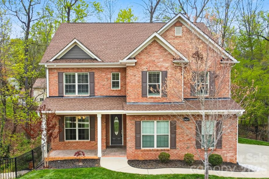 Quietly positioned at the end of a cul-de-sac in south Charlotte, this all-brick home offers a rare combination of privacy, quality construction, and thoughtful design. The floorplan feels spacious and well-composed throughout — the kind of layout that accommodates real life without sacrificing style. Mature trees, a wooded backdrop, and no immediate neighboring homes create a naturally secluded setting, while the location keeps everyday convenience well within reach.

Inside, tall ceilings and oversized interior doors lend the main level a refined, airy character. Finishes and upgrades throughout are polished and intentional, giving the home a distinctly elevated feel.

The kitchen is a true centerpiece — anchored by a large island and breakfast bar, with generous counter space, a sunny eat-in area, and a walk-in pantry that keeps things beautifully organized. A butler's pantry adds additional prep and storage space, making entertaining feel seamless. The kitchen opens directly into the living room, where a gas fireplace adds warmth and ambiance — an ideal layout for gathering, hosting, and everyday connection. A separate formal dining room sits just off the kitchen, ready for the occasions that call for a proper table setting.

 The sunroom extends the living space beautifully, offering a bright, comfortable room that works year-round — morning coffee, a reading nook, or a relaxed space to enjoy views of the wooded backyard. Outside, the fenced yard and brick paver patio provide a private, tree-lined setting ideal for outdoor dining, entertaining, or simply unwinding.

The large main level suite is a genuine standout — spacious, private, and appointed with a full bath and walk-in shower. Whether for guests, extended family, or multigenerational living, it functions as a true retreat rather than an afterthought.

Upstairs, the primary suite delivers an elevated sense of comfort, with a tray ceiling, soaking tub, separate shower, and generous vanity space — a well-designed escape at the end of the day. Additional bedrooms are well-proportioned and thoughtfully sized, with one oversized room offering real flexibility as a media room, home gym, playroom, or whatever the next chapter calls for. An upper-level laundry room adds the kind of everyday practicality that's easy to appreciate.

The outdoor living space is a true extension of the home and every bit as considered as the interior. A custom brick paver and stamped concrete patio wraps the back of the house with a finished, intentional feel, anchored by a curved natural stone seating wall that's as functional as it is beautiful. Mature trees surround the property on all sides, creating a canopy of privacy that feels truly tucked away. Whether you're entertaining under the trees, enjoying a quiet evening by a firepit, or simply taking in the view — this backyard delivers that rare, secluded feel that's hard to find this close to the city.


A side-entry garage and quiet cul-de-sac positioning add to the home's refined curb appeal, while the all-brick exterior ensures lasting quality and low maintenance.

Set in one of southeast Charlotte's most established and convenient corridors, the home is minutes from The Arboretum at Providence Road and Highway 51, with a strong mix of everyday shopping, dining, and services. Downtown Matthews is just down the road, offering a charming small-town feel, local restaurants, and the region's largest producer-only farmers market. SouthPark — Charlotte's premier destination for luxury retail and fine dining — is an easy drive, and major corridors provide straightforward access to Uptown and the broader metro. This home provides the best of both worlds: a private, serene setting with every convenience, restaurant, and entertainment option right at your doorstep.