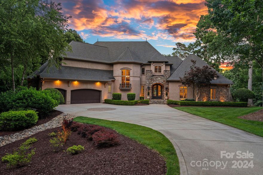 This exquisite luxury home, built by Augusta Home in The Point, offers stunning views of Lake Norman and the 8th tee and 7th green of Trump National Golf Club Charlotte. Every detail has been meticulously cared for, ensuring a captivating experience with lake views from most rooms. The home features a screened-in porch with a gas fireplace for perfect relaxation. The updated chef's kitchen, equipped with luxury appliances and a butler's pantry overlooking the porch, makes entertaining a delight. The main level owner's retreat is a spa-like haven with new fixtures and a remodeled closet. The grand staircase leads to the second level, an entertainer's paradise with a billiards room, bar, and media room. A secondary primary suite on this level includes a balcony with lake views. The unfinished basement is ideal for storing recreational toys or a golf cart and includes a half bath for backyard entertaining. Additionally, a deeded boat slip is just a short distance away.