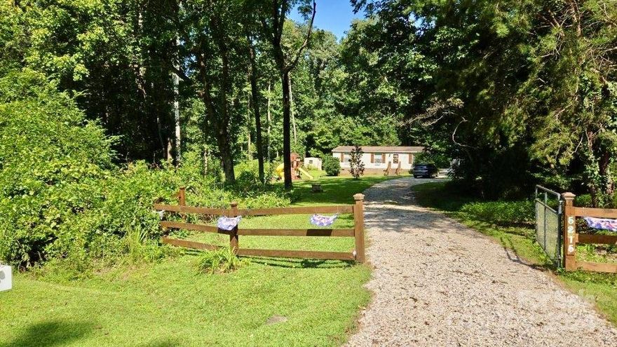 Welcome Home to 5215 CR Wood Rd! This delightful 2-bed, 2-bath country home w/split bedroom floor plan is nestled on a private 2.99-acre (3.018-acre per survey) lot in the suburbs of Gastonia, where there’s no HOA to limit your freedom. The stunning front door, crafted from pine, adds a unique country charm to the home. Its handmade quality & natural wood grain create a warm, inviting entrance. Step inside to a semi-open concept living area, perfect for entertaining friends & family. The spacious kitchen features plenty of cabinet & counter space, including a convenient center island for meal prep & casual dining.  A large primary bedroom offers an abundance of living space. Outback is your personal sanctuary; a large, oversized screened deck surrounded by mature trees, providing a peaceful getaway for relaxation. Additionally, a 8x16 shed will provide endless possibilities, whether for storage, he/she shed or your next project. Third bedroom used as a playroom/bonus room.