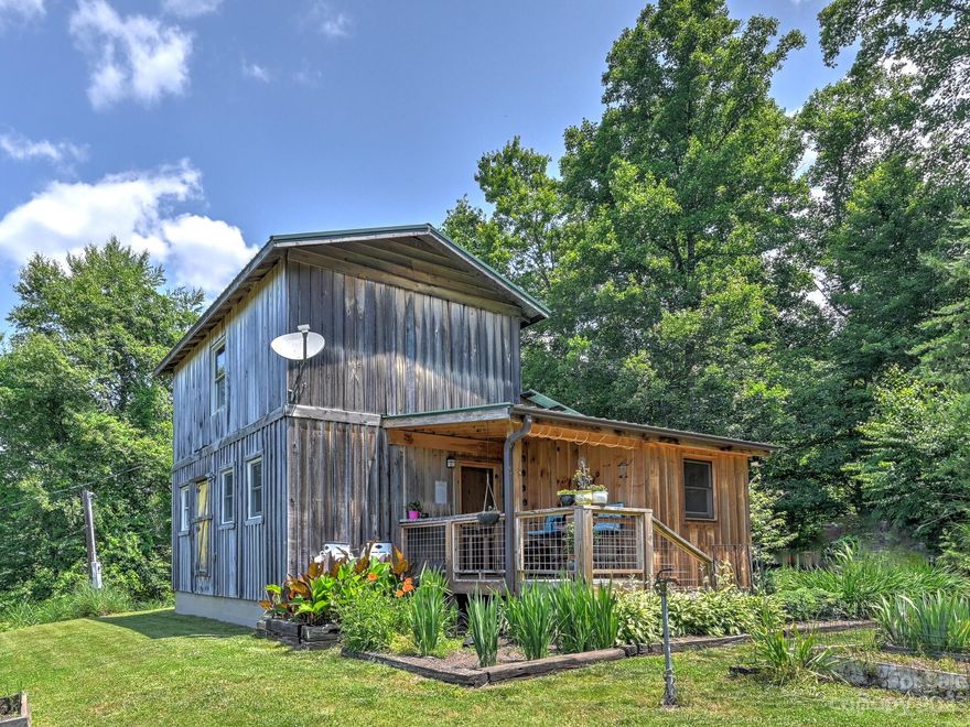 MULTIPLE OFFERS,  SELLERS ARE REQUESTING HIGHEST AND BEST OFFERS BY 7:00PM SUNDAY 06/25/2023.   
A great escape from the hustle and bustle, but only 10 minutes from either Mars Hill or Marshall.  Beautiful mountain views from this cozy 1.5 story retreat nestled into the hardwoods with spectacular mountain views.  Your own 10 acres to hike and enjoy running to the top of the mountain.  Great opportunity for vacation home, vacation rental, or full time living.  Main level offers intimate den, luxurious full bath with rain shower, and the main bedroom.    Several outbuildings for storage and workshop with one building being hardwired with electric and utilized as a home office.  Property has French Broad Electric fiber internet.  Priced to sell but with tremendous potential to add value.  Sellers intend to take some plants.  Full bathroom mirror does not convey.  SEE SURVEY:  SUBJECT PROPERTY SUBJECT TO WATER RIGHTS TO SPRING.  HASN'T BEEN USED IN YEARS, BUT RIGHTS DO EXIST