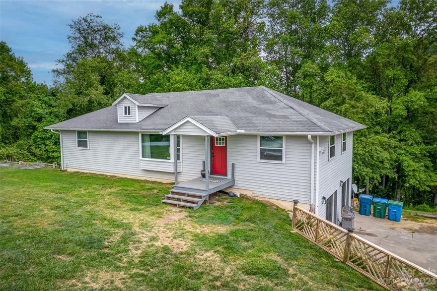 Welcome to 127 Hawke Crest Road! This home is situated on a spacious .96 acre lot with winter mountain views, raised garden beds, plenty of room for outdoor activities, many perennials carefully placed around the property, AND invisible fencing along the perimeter. Enter the home to find vaulted ceilings and natural light in the living area & kitchen. The open layout connects the living room to the dining area and leads out to the back deck, perfect for entertaining guests. Enjoy updated stainless steel appliances in the kitchen! The primary suite includes a gorgeous vintage claw foot tub, double sinks, tile shower, and open closet. Two additional bedrooms and a full bathroom are also on the main level. The partially finished basement offers a bonus room and full bathroom. Many possibilities for use of the unfinished basement space such as office, crafting, or playroom. Recently installed hot water heater, new windows and interior doors throughout.