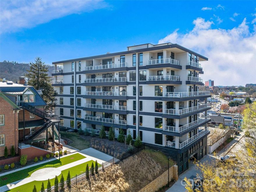 6TH FLOOR UPTOWN VIEWS & MT PISGAH! Experience modern mountain luxury in the heart of vibrant Downtown Asheville from this first-time offered, north-facing home with unobstructed views of Uptown Asheville. This two-bedroom split plan/two full bath condominium at 145 Biltmore offers stunning uptown and mountain views from the 6th floor. Enjoy a spacious wraparound balcony/deck plus two Juliette balconies, perfect for soaking in the scenery, including Mt. Pisgah. Imagine the Downtown twinkle of lights, mountain views, and overlooking some of Asheville's most historic homes. The well-designed open-concept layout features one-level living, a private primary suite, dining area, generous storage, and one gated garage parking space—rare in downtown. Step outside to Asheville’s finest restaurants, breweries, shops, arts, and entertainment. Luxury, location, and lifestyle await! An additional parking space is available if desired.