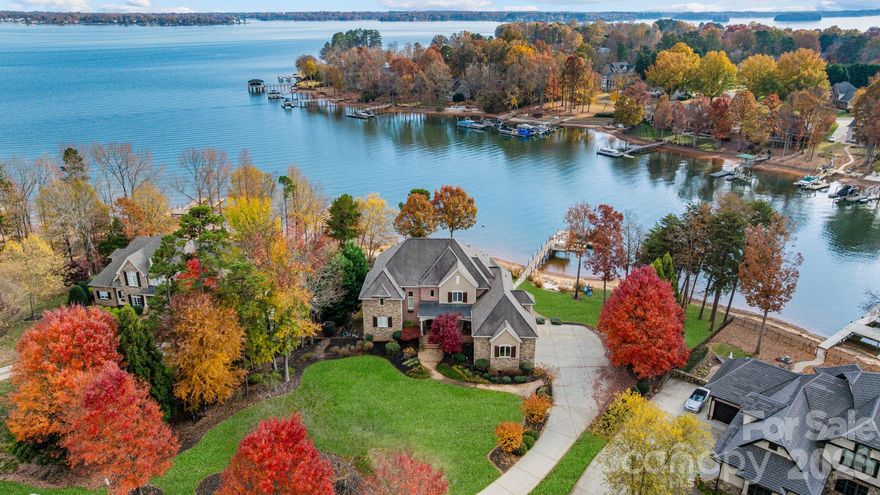 Refined waterfront living awaits in the highly desirable Point neighborhood on Lake Norman. This exceptional home offers serene lake views, a private dock with boat lift, a sandy beach, and effortless access to life on the water, ideal for boating, paddleboarding, and peaceful evenings by the lake. Thoughtfully designed for both elegant entertaining and everyday comfort, the home features open, light-filled living spaces, a chef’s kitchen, and a main-level owner’s retreat, along with multiple indoor and outdoor areas to relax and gather. The beautifully landscaped backyard highlights a resort-style pool and expansive patio, creating a private setting for enjoying the outdoors. A walk-out lower level adds versatility with additional space for recreation, theater, and guests. Ideally located in Mooresville, just north of Charlotte, this home offers a lifestyle defined by the best of Lake Norman living, from boating and waterfront dining to charming local shops, community events, and year-round outdoor recreation, all within an established and highly regarded lakeside community.