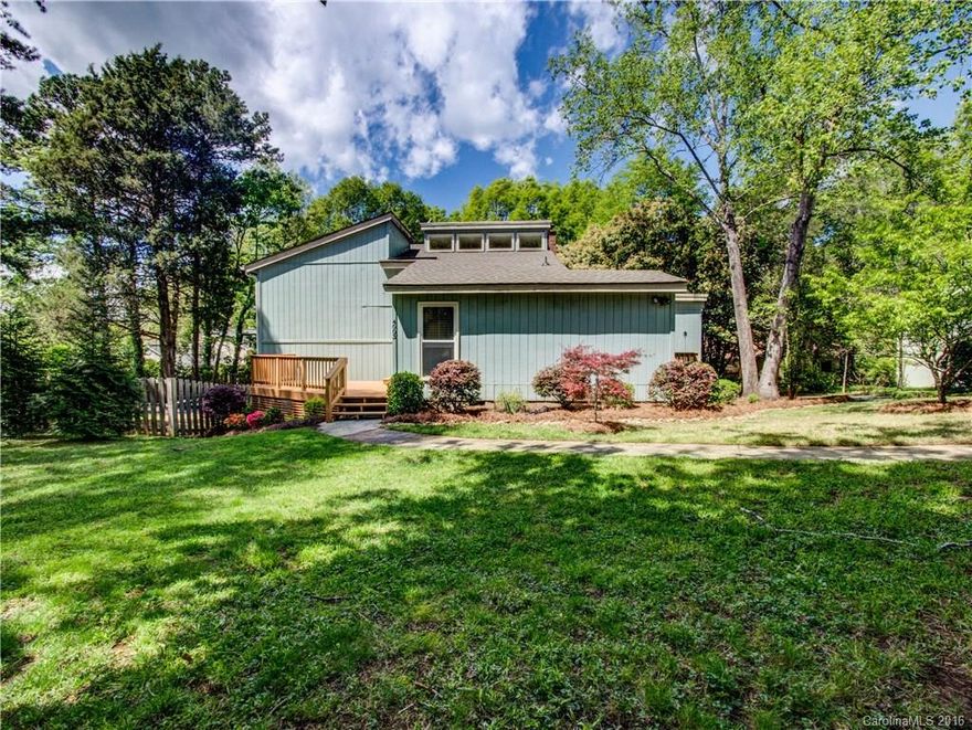 Charming, spacious home, nestled on a private lot, in the heart of the Tega Cay peninsula. The home features a grand, two story great room complete with an abundance of natural light & wood-burning fireplace. Owner's suite includes large walk-in closet with a private deck overlooking the tree-lined lot. 3 additional bedrooms with a second family room & fireplace on the lower level. Fenced in yard with paver patio. One car, attached garage. Plus NEW paint throughout! NEW HVAC! NEW flooring!