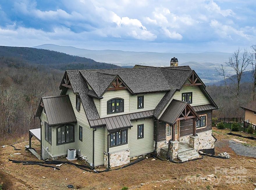 Discover the rare opportunity to own a custom new-build luxury home in the prestigious, gated community of Grand Highlands at Bearwallow. Under Construction and offered as-is, this over 3,000 sq ft mountain retreat is perched to capture breathtaking, unobstructed long-range mountain views that truly have to be seen to be believed. Thoughtfully designed with soaring ceilings, exquisite woodwork, and expansive accordion doors that open onto generous decks, this home seamlessly blends indoor luxury with the majesty of the outdoors. Every angle was crafted to showcase the views, offering a sense of serenity and grandeur at every turn. This home is awaiting your personal touch to bring it to life. You'll also enjoy world-class community amenities including a clubhouse, tennis and sport courts, scenic walking trails, a community barn and even a heli pad, all nestled within a tranquil gated setting. Come finish what’s been started and make this one-of-a-kind mountain sanctuary your own.