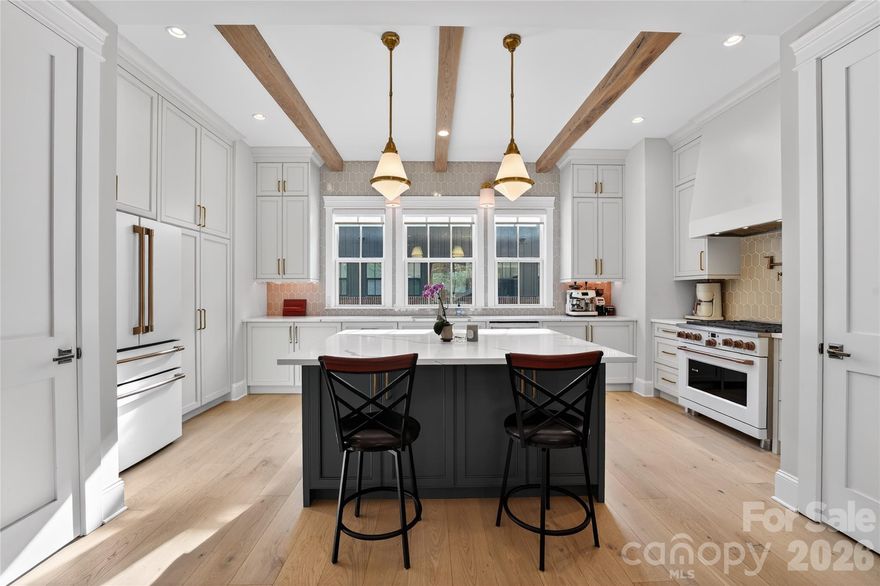 Experience unparalleled luxury and convenience in this stunning end-unit townhome with over $70k in upgrades. It is perfectly situated just steps to the best that Myers Park has to offer, including the Sugar Creek Greenway, Park Road Plaza, and Selwyn Corners. This home offers the ultimate walkable lifestyle. Inside, you're greeted by abundant natural light and exquisite custom finishes, including bespoke cabinetry and built-ins. The chef's kitchen is an absolute showstopper, featuring premium Cafe appliances, pot filler, gorgeous high-end fixtures, and a clever custom pocket pantry. Entertain effortlessly in the main living space, anchored by a sleek Napoleon Vector Series fireplace.

The thoughtful layout features a highly desirable first-floor guest suite with a private full bath. Upstairs, you will find dual primary suites, both boasting luxurious dual-vanity en suite bathrooms. All full bathrooms feature rainfall shower heads and wands. Beyond the bedrooms, the upper-level loft is an entertainer’s dream, complete with a wet bar and custom cabinetry that seamlessly transitions out to a spectacular screened-in rooftop terrace.

Practicality meets modern design with a fully equipped laundry area featuring a sink, a fenced-in front yard, a 2-car garage, and expansive attic storage. Designed as a tech-lover's dream, the home is completely future-proofed with thoughtfully added outlets, hidden conduit, two EV charging outlets, and Cat6 ethernet throughout. Don't miss this rare opportunity to own a turnkey masterpiece in one of Charlotte's best neighborhoods!