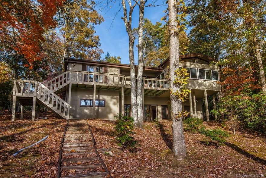 Lakefront home nestled in quiet cove updated with hardwood floors thru-out main level. LivingRm enhanced with vaulted ceiling, skylights, built-in bookcases and a brick FP that is 2 sided to the Dining area for added ambiance. Lake side Master has 3 sets of closets. Newer kitchen includes Ctr Isl, granite cntrs, greenhouse window & vaulted ceilings. Spacious Sunroom overlooking Lake along with 28' rear deck. FamilyRm, 2BR's & Bath on LL w/ large laundry, WIC, workshop. Easy walk to private dock