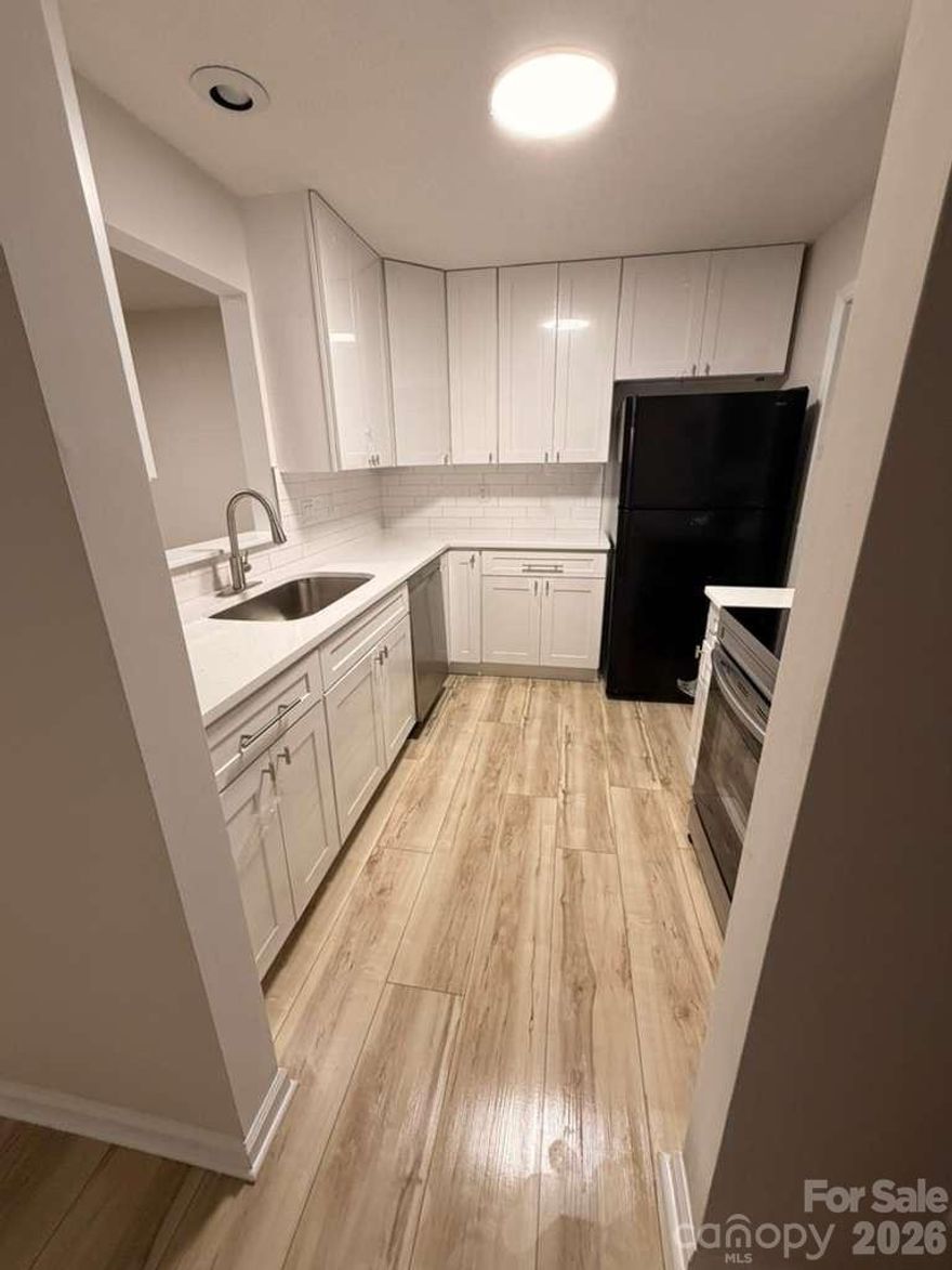Top level unit with high vaulted ceilings overlooking the courtyard and pool. Short walk to University Place shops and restaurants. Right across from UNCC, University Hospital and the light rail.  This unit is the only entrance on the top level of the stair column providing extra privacy and space.  New flooring, new ovens, and windows replaced in 2024. Fresh paint, kitchen updated, updated bathrooms, move in ready. Refrigerator remains. The HOA fee covers the pool, other amenities, trash, water, common areas, and all exterior maintenance. Use as a rental!