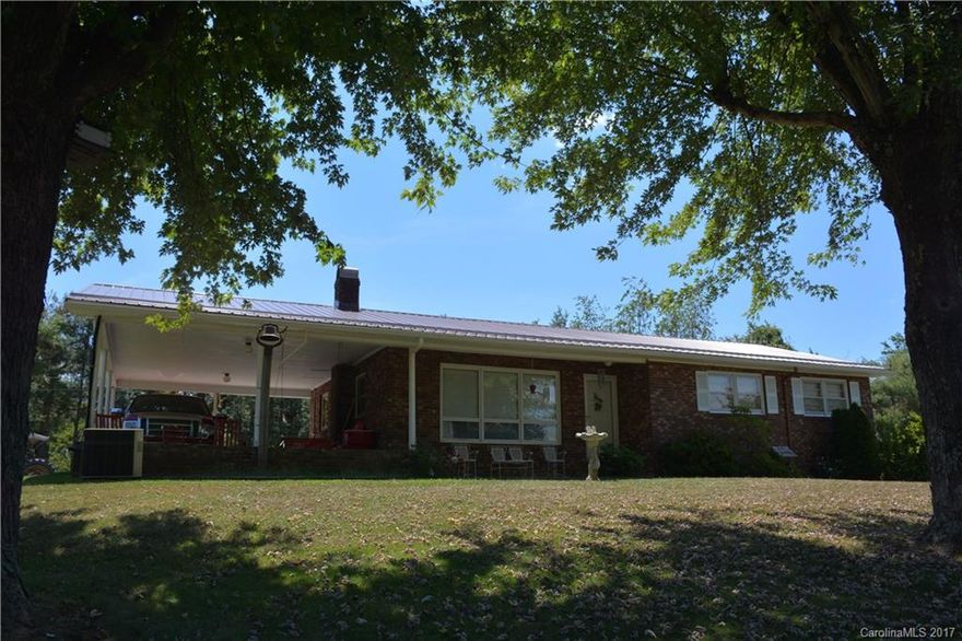 Single owner, brick rancher, gas fireplace & a daylight bsmt w/ apt & additional office/studio. Lovingly built in 1975, this home sits on a knoll & includes a lovely 13+ acres w/ extensive long range & short range mtn views, fenced pastureland & abundant water access along the Big Ivy River. Well-maintained home has 3BR, 2BA, LR & separate den on main level plus a full apartment potential on lower level w/ 2nd kitchen, living room, 2  bonus rooms, additional full bathroom & separate entrance.