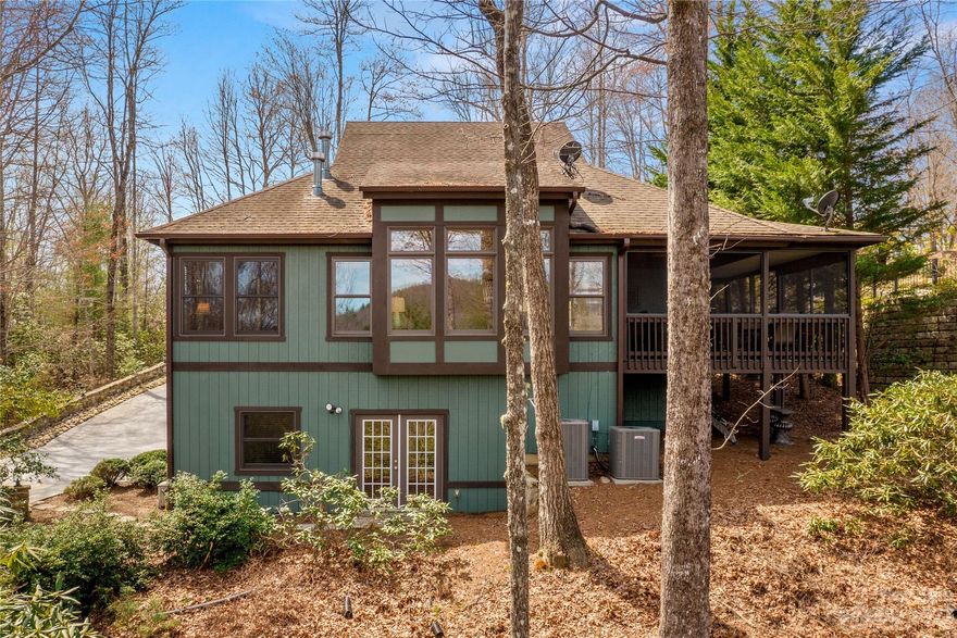 Quintessential mountain home in Connestee Falls Community with STR history. The open-concept floorplan, highlighted by vaulted ceilings adorned with exposed beams, creates an inviting ambiance. Kitchen features a tile backsplash and island with breakfast bar. The Living room has abundant natural light, stone fireplace with gas logs and access to wraparound covered porch. The primary suite features vaulted ceilings and cozy seating area with fireplace. Ensuite bathroom offers a soaking tub, tiled shower, water closet, and walk-in closet. 2nd bedroom and bathroom on main level, spacious upper-level bedroom and bathroom for guests. The finished basement has versatile family room that could be used as 4th bedroom, with separate outdoor entry. A full bathroom, two storage/workshop rooms and two-car garage cater to practical needs. Screened porch on front of home wraps around to covered deck with mountain views. All furnishings convey. New owner Amenities fee of $10,500 paid at closing.