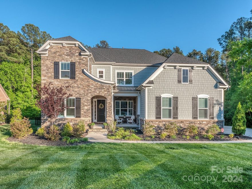 This immaculate home, constructed in 2020, exudes a fresh, modern vibe with its pristine light-colored flooring, neutral paint and gleaming white kitchen. The main level combines elegance and practicality, offering a well-appointed kitchen, expansive island and ample counter space, a spacious office, open-concept family and dining areas, a sun room, drop zone, and a welcoming guest bedroom. Upstairs, you'll find the generously sized primary suite with ensuite bathroom, twin walk-in closets, a sizable bonus room, and two bedrooms connected by a Jack-and-Jill style bathroom. The screened-in porch off the dining room has a beautiful stone fireplace. The new deck (2022) is adorned with a pergola and privacy feature and leads down to a stunning backyard sanctuary where you can enjoy a pool, hot tub, cascading waterfall, tiled patio and built in grill. Backyard is completely private, surrounded by lush trees and greenspace. This home looks and feels brand new and ready for immediate move-in!