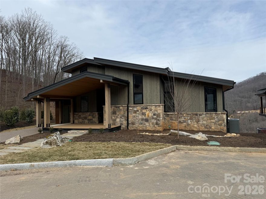 Location, Views and Elevation. Perched on the front row of the desirable Doubletop Village, this home overlooks the gorgeous Palmer Practice Park and the mountains beyond. Just steps away from the award winning clubhouse at Balsam, you can walk to dinner and enjoy a great evening by the stone village fireplace. If you prefer to travel by golf cart, this is the only community within Balsam that allows you to. At 3,500 feet of elevation, you will enjoy cool summer days as you sit outside and watch the mountains come alive. This incredible home represents the epitome of mountain modern architecture, combining spaciousness and luxury with utmost versatility. Featuring three bedroom suites and a fourth built-in bunk room, it's ideal for entertaining friends and family. With its clean, natural lines, abundant windows, airy kitchen, white oak flooring, stone gas fireplace, and expansive deck, this home is a perfect fusion of indoor and outdoor living. For those seeking a lock and leave solution, you won't find anything better. The home is being sold fully furnished for you to enjoy immediately. Balsam Mountain Preserve is a private 4,400 acre club community with 3,200 acres of conservation land and completed amenities featuring golf, equestrian, scenic trails, tennis and multiple dining venues.