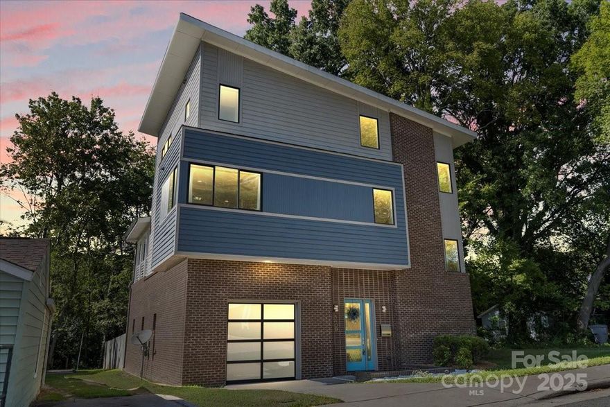 Welcome home to this stunning luxury Belmont contemporary home. The perfect retreat for busy commuters as you are one block from and can walk to the Parkwood Blue line station (5 minutes to Uptown), near the Greenway and minutes to NoDa. The open floor plan second level includes a modern kitchen that features SS Kitchen Aid appliances, premium cabinets, and a huge Island for entertaining guests and dining. The third floor primary bedroom is light filled with vaulted ceilings and a large closet. The spa like primary bath features marble floors, a massive tiled shower, separate soaking tub, upgraded fixtures and dual vanities. Two additional bedrooms each have an attached full bathroom. Beautiful gleaming hardwood flooring covers all three floors.  The house was recently freshly painted both interior and exterior. The home has a backyard deck from the first floor and a huge covered terrace from the second level that overlooks the greenway and the fully fenced backyard.  There is an attached 2 car garage with extra room for storage. Do not let this opportunity to live so close to Uptown in luxury get away.