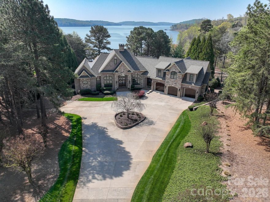 Magnificent lakefront retreat with private pier only an hour from Charlotte and The Triad! This stunning home on 1.3 acres boasts panoramic views of Badin Lake and the Uwharrie National Forest. Prime location in The Old North State Club’s exclusive lake and golf community. Unbelievably luxurious owner’s suite and chef’s kitchen. Ample space to entertain with 5 bedrooms, 2 kitchens, guest suite with kitchenette, study, theater room, wine cellar and 2 laundry rooms. The spectacular infinity edge hot tub, fire pit, screened porch with built-in grilling station and covered veranda provide an oasis of year-round outdoor living. Join The Old North State Club to enjoy dining, fitness, pools, courts and a full-service marina. Don’t miss out on this special home!