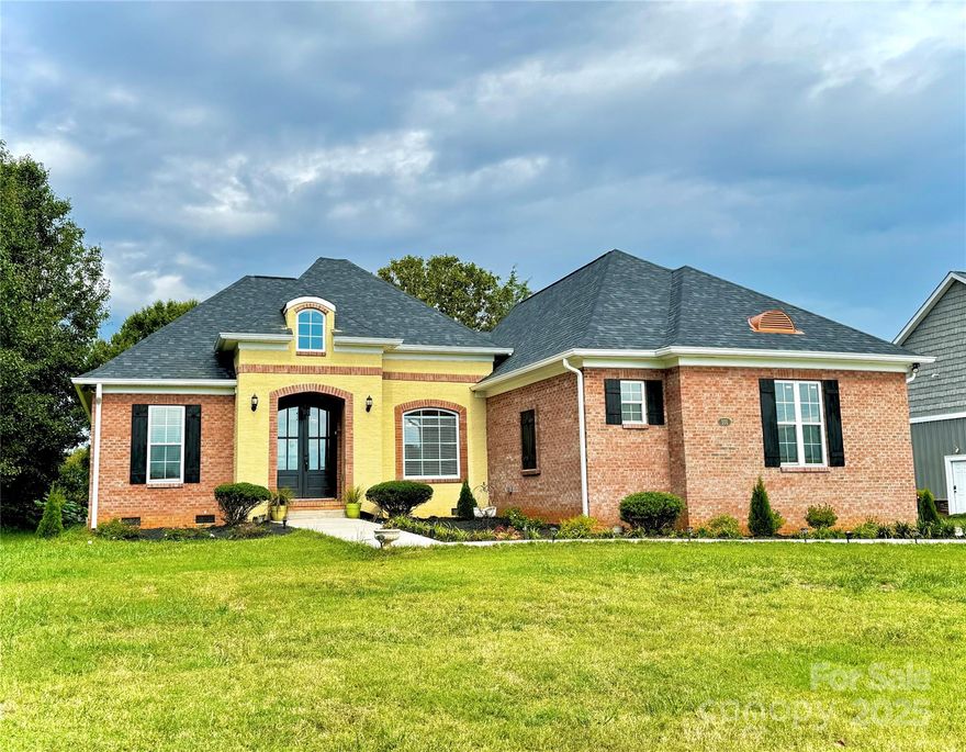 Beautifully set on a corner lot of over half an acre, this 3 bedroom, 2 bath brick home offers both space and style. The split-bedroom layout provides roomy bedrooms and privacy, while the open design brings together the great room, dining area, kitchen, and breakfast nook in one seamless living space. The great room showcases custom built-ins and luxury vinyl plank flooring throughout. The kitchen stands out with granite countertops, stainless steel appliances, a large center island, and custom cabinetry. The spacious primary suite features a well-appointed bath with a dual vanity and a soaking tub. This home features a thoughtfully designed, functional, and well-laid-out floor plan.