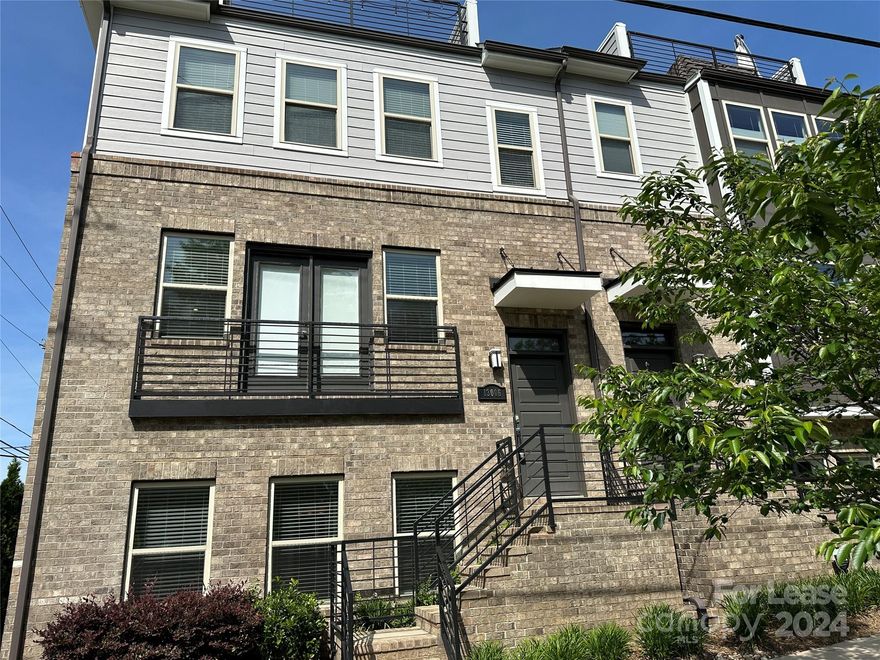 Fantastic 3 bedroom, 3 full bath, & 2 half bath townhome in the Central Point community of Charlotte. Open floorplan w/great room & kitchen, offering spacious & appealing living space, features crown molding, modern light fixtures &  wood flooring. The eat-in kitchen is upgraded w/quartz countertops, an island breakfast bar, stainless steel appliances & tile backsplash. The living area opens to a balcony above the 2-car garage. The lower level features a flex/bedroom w/en-suite bath.  The primary bedroom is on the 2nd floor, and boasts a large walk-in closet and en suite bath with dual vanities w/subway-tiled walk-in double shower. Also on this level is the laundry room with included washer and dryer, and another bedroom with a walk-in closet and en suite bath with a tiled shower. The third floor completes the home with a bonus room w/half bath and access to the rooftop terrace. Amazing view of the uptown Charlotte skyline! Water and lawn care are included in the lease.