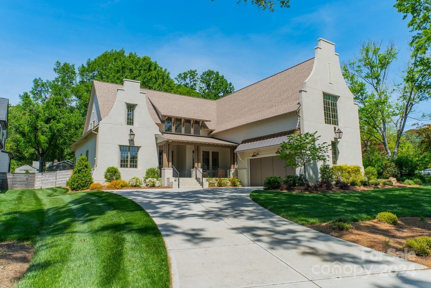 This Cape Dutch-inspired residence sits on a serene Cotswold home built by Pike Properties. It features custom cabinetry, a 48” Jenn-Air range, separate fridge/freezer columns, a Brizo faucet with pot filler, and a center island with seating for 4 in the kitchen. A Scullery houses a dual-zone 141-bottle wine fridge, secondary dishwasher, prep sink, and ample storage. The dining room flows into the 12' vaulted living room w/sliding doors out to the stone terrace with an outdoor fireplace and screened porch. The main level primary suite has a large walk-in shower, a black cast iron freestanding tub, and an expansive walk-in closet. A statement powder bath connects to a zero-entry shower attached to the main floor guest bedroom or as an office space. A 400 sq ft bonus room upstairs has a dry bar and beverage fridge. All secondary bedrooms have en-suite baths and are placed on separate corners of the home. And, conveniently located near Charlotte Swim & Racquet Club, Cotswold's hidden gem!