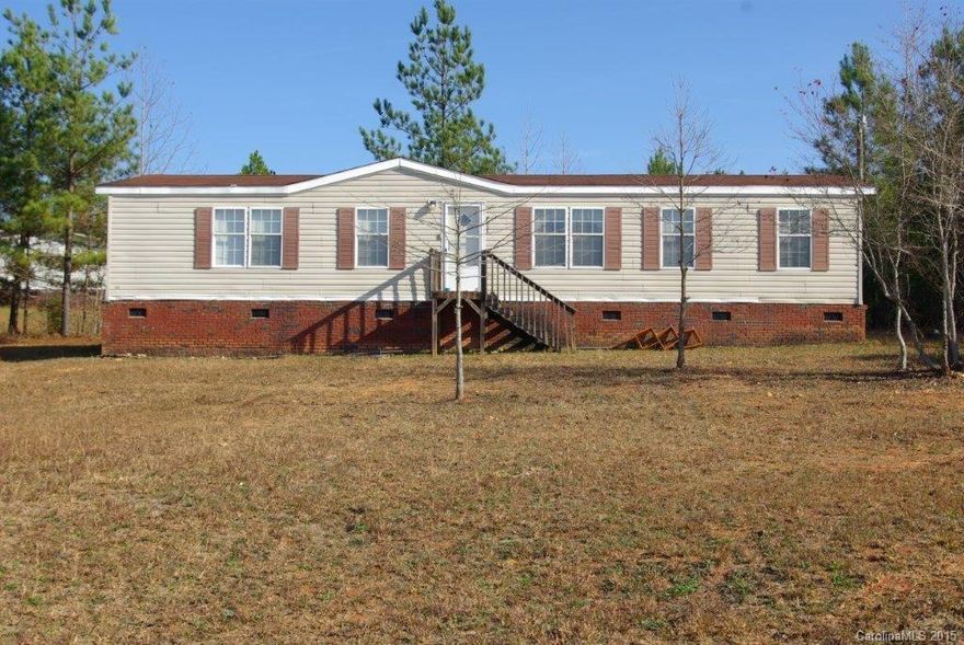Double-wide mobile home on 1+ acres.  3 bedrooms, 2 full baths.  Family room with wood burning fireplace, dining area, kitchen and laundry area.  SOLD AS IS.