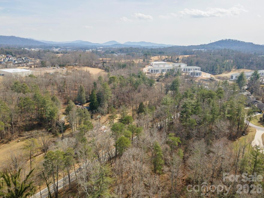 This is a 16 acre +/- site that is zoned EMP allowing for a variety of uses.  Water and sewer are available.  There is currently a single family home and a few small outbuildings located on the site. 
 
The site is proximate to The Arboretum, Blue Ridge Parkway, French Broad River, Asheville Airport, shopping centers and restaurants.

This site is the same PIN# as a 4.2 acre site located across Brevard Road.   Assemblage of 20 + acres is possible.